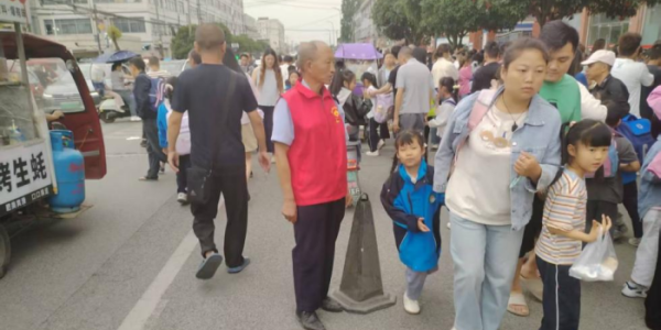 成都市新都区新繁街道普文社区关工委志愿者护航放学路 爱心指挥守护出行安全